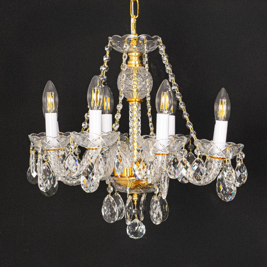 Gold metal crystal chandelier shown on black background highlighting premium crystal detailing for elegant interiors.