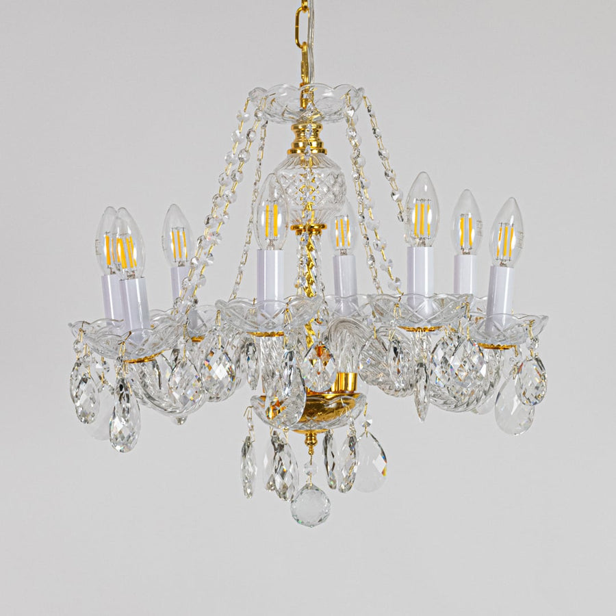 Gold metal crystal chandelier displayed on white background ideal for classic bright interior ceiling styling.