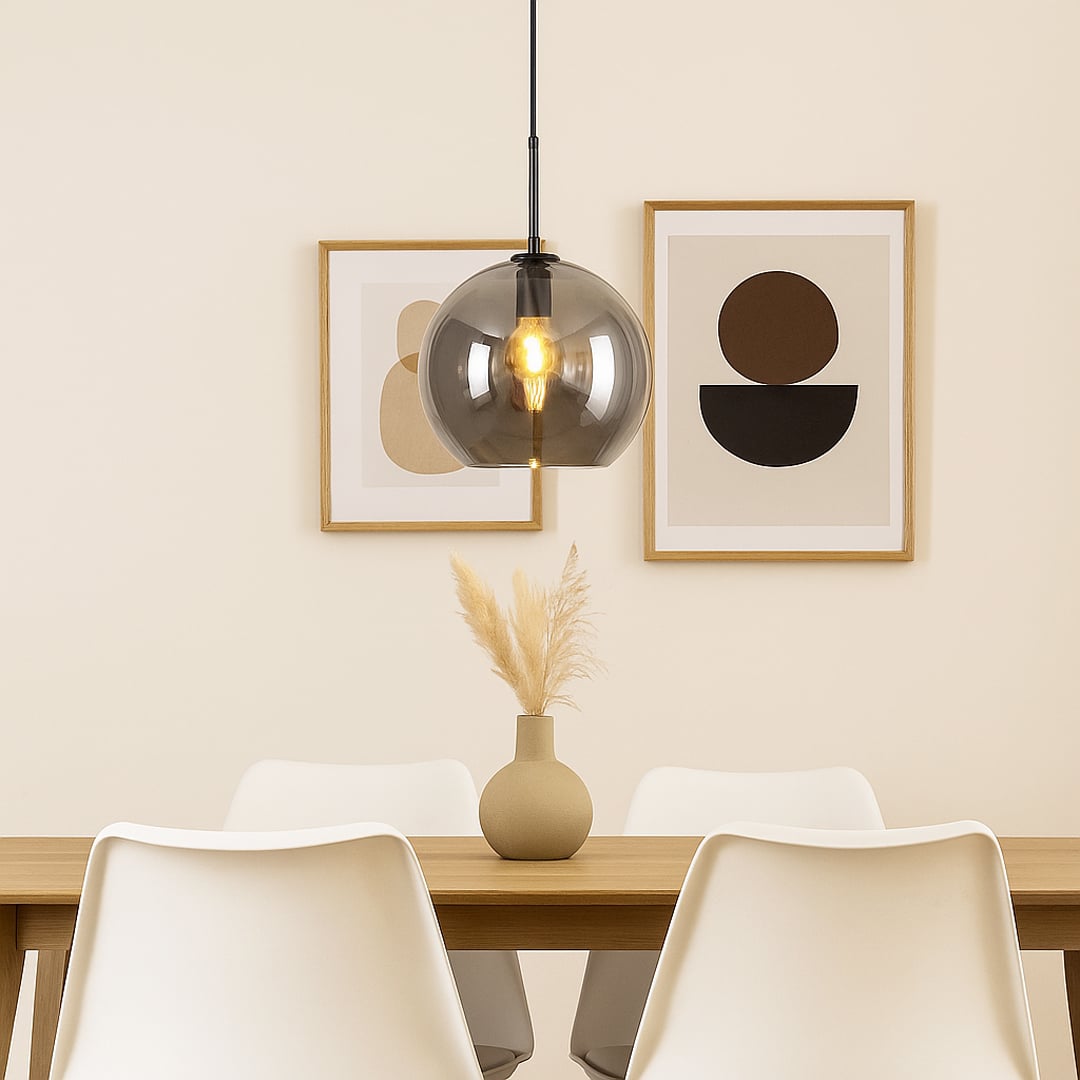 Pendant light with smoked glass shade and metal fitting hanging above dining table creating soft illumination and modern dining room style.