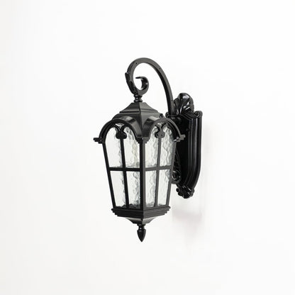 Outdoor wall lantern in black metal with textured glass switched off on white background highlighting classic lantern design.