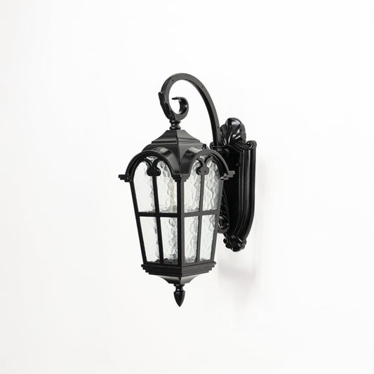 Outdoor wall lantern in black metal with textured glass switched off on white background highlighting classic lantern design.
