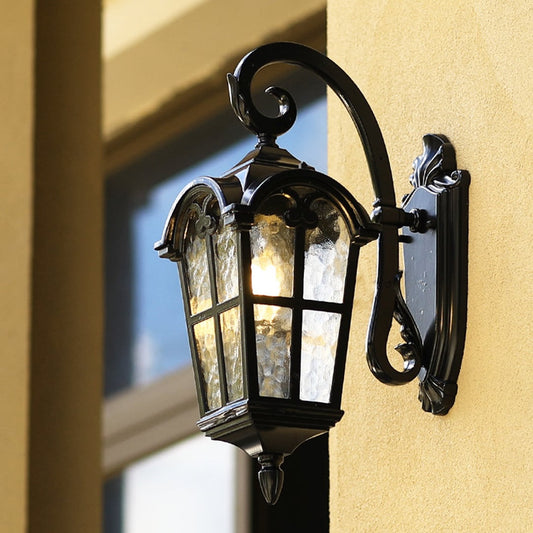 Main lifestyle view of outdoor wall light lantern with classic black frame and frosted glass panels illuminating entrance decor.