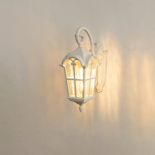 White vintage outdoor wall light on white background with textured glass panels casting a warm and dramatic radial glow.