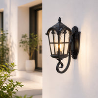 Traditional black metal outdoor wall lantern for porch entrance balcony and exterior walls with warm ambient lighting.