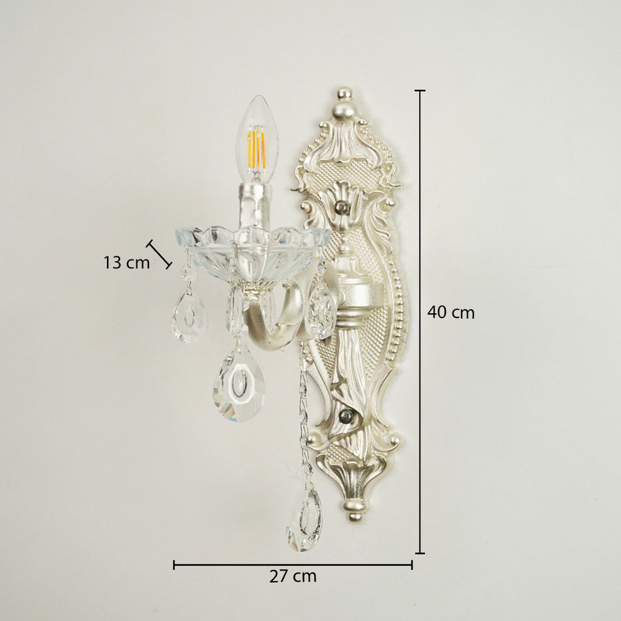 Silver wall sconce with clear glass crystal teardrop pendants, shown with dimension markings of 27 cm width, 40 cm height, and 13 cm arm depth against a plain light background.