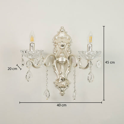 An ornate silver wall sconce with two clear crystal candle-style bulbs and hanging crystal drops, shown against a plain light background with dimension labels indicating 40 cm width, 45 cm height, and 20 cm bulb/crystal spacing.
