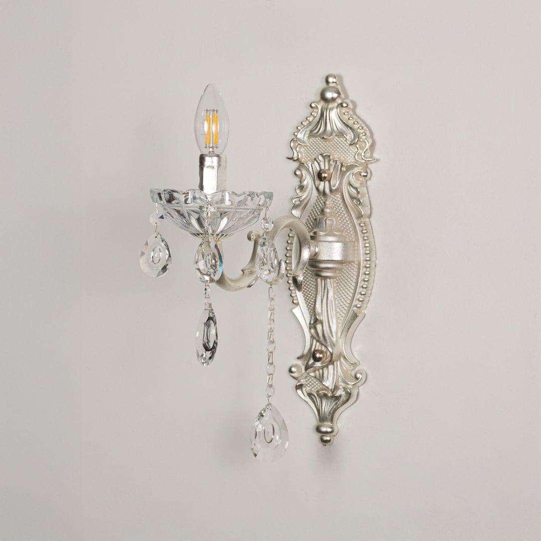 Wall light with silver metal frame and crystal accents displayed on a white background for clear product detailing.