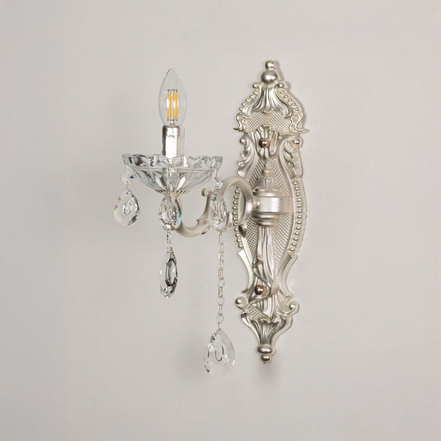 Wall light with silver metal frame and crystal accents displayed on a white background for clear product detailing.
