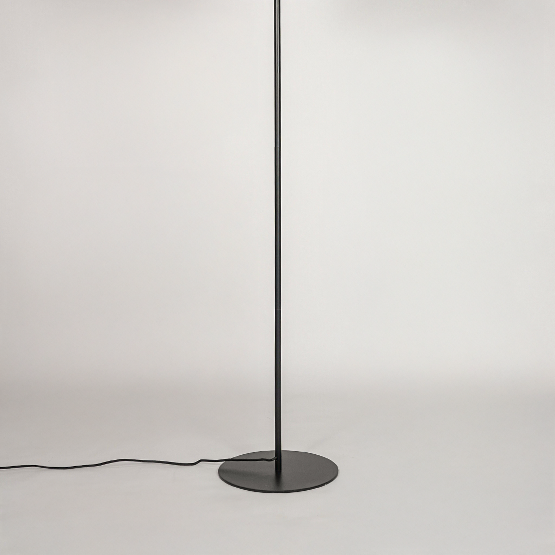 White background image of black metal floor lamp base for elegant living room decor styling and modern home lighting setup.