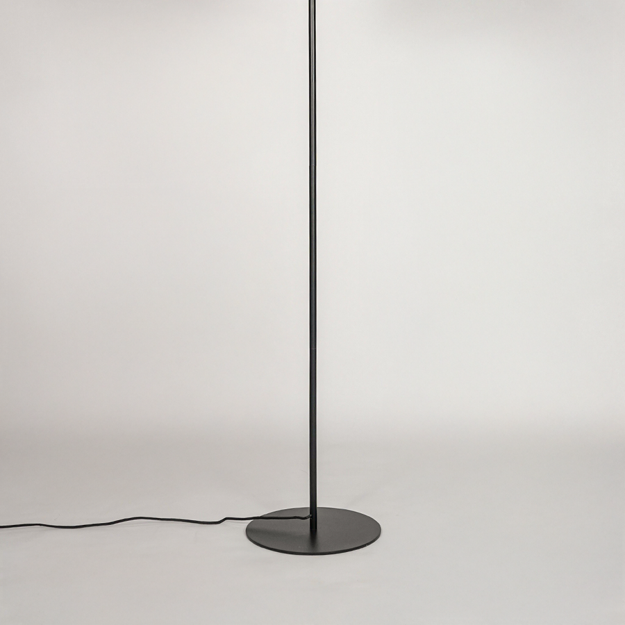 White background image of black metal floor lamp base for elegant living room decor styling and modern home lighting setup.