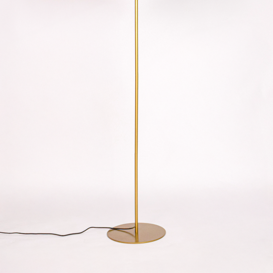 White background image of gold metal floor lamp base for elegant living room decor styling and modern home lighting design.