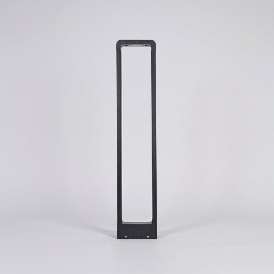 Contemporary outdoor bollard light with slim black frame and frosted panel on neutral background ideal for modern garden or driveway lighting.