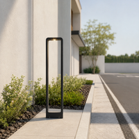 Sleek minimalist black aluminum outdoor bollard light for driveway walkway concrete pathway and modern landscape styling.