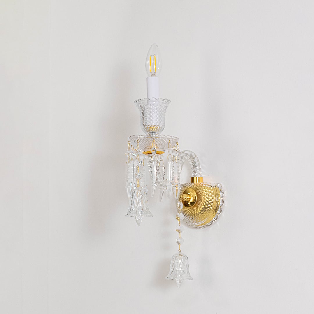Double arm crystal wall light with detailed glass design and crystal drops turned off on white background.