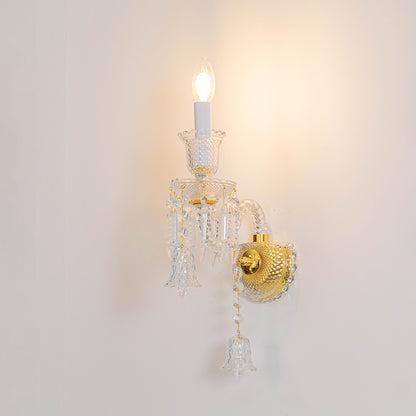 Classic crystal wall light in gold finish with single candle bulb for bedroom or living decor lighting white background.