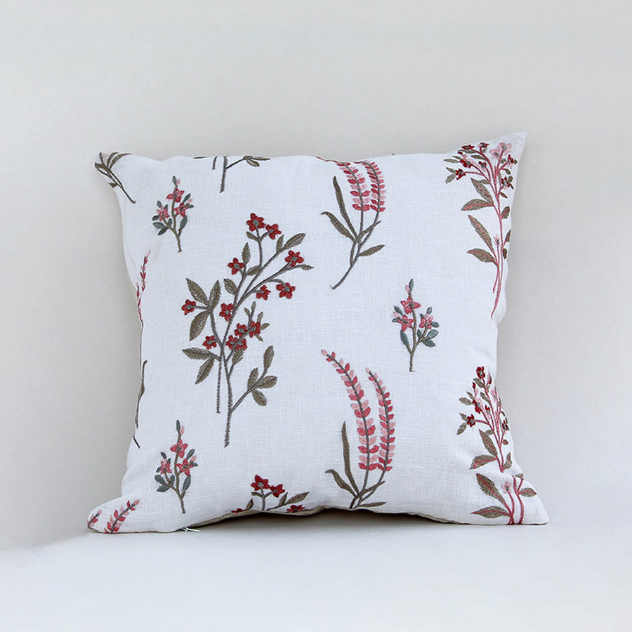 White cushion cover with red botanical floral print on soft fabric designed for sofa chair and bed home decor styling.