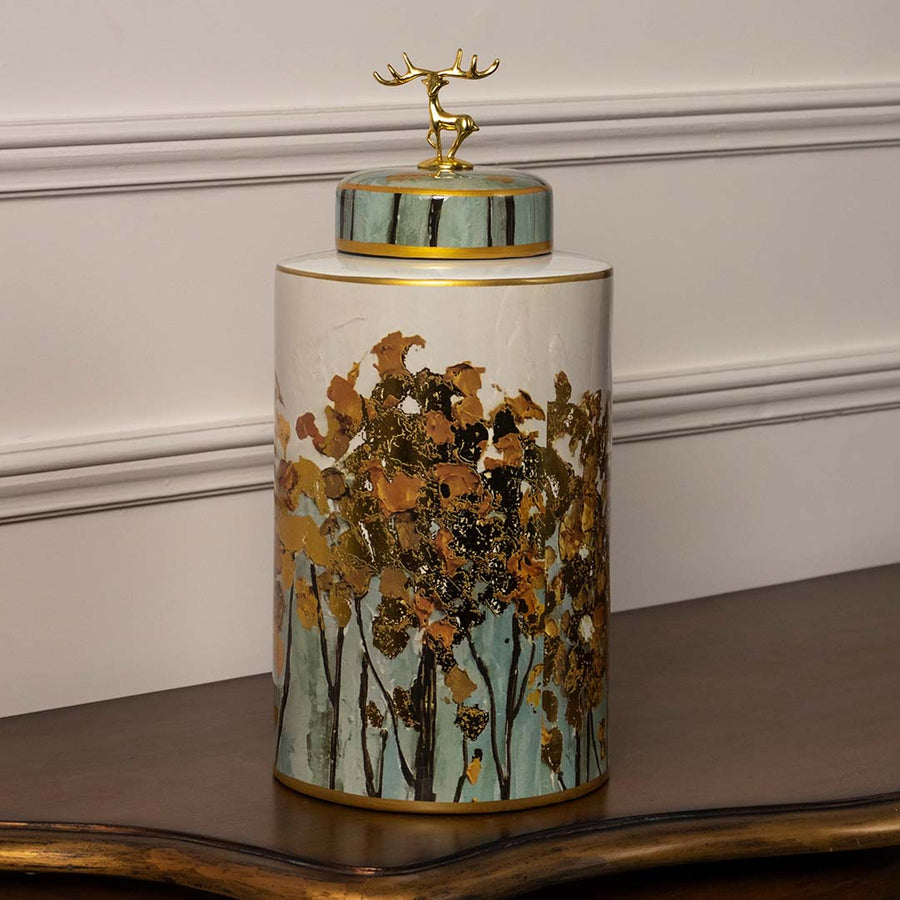 Luxury ceramic decor jar in white and teal with hand painted forest design and golden highlights for modern interiors.