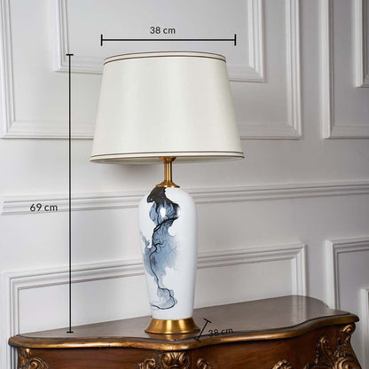 White ceramic table lamp shown with 69 cm height 38 cm shade width and 38 cm base width on a wooden console for accurate size reference.