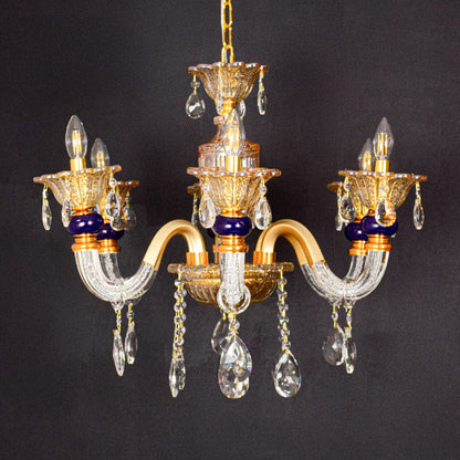 Gold and clear crystal chandelier shown on black background highlighting rich elegant detailing for premium interiors.
