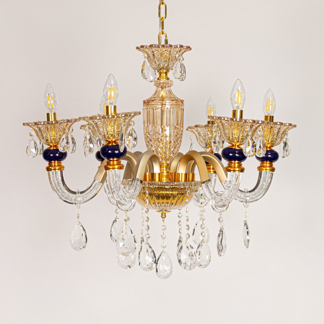 Gold and clear crystal chandelier displayed on white background ideal for classic warm interior ceiling styling.