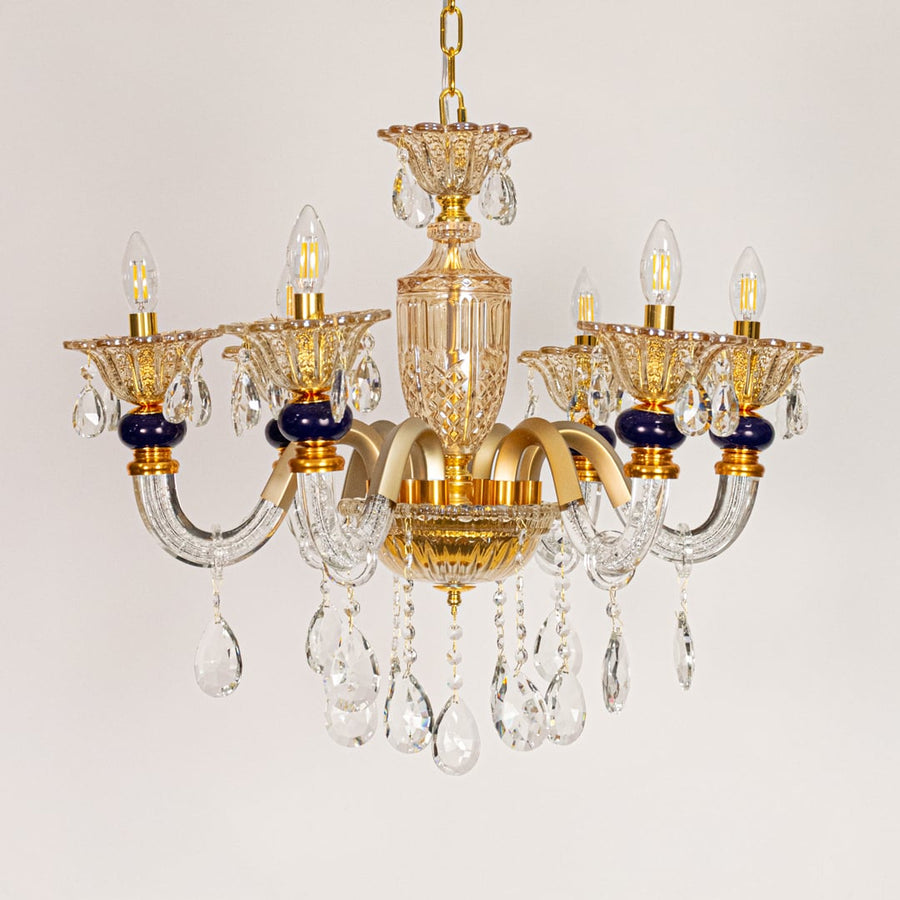 Gold and clear crystal chandelier displayed on white background ideal for classic warm interior ceiling styling.