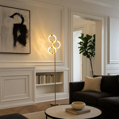 Contemporary floor lamp with circular metal light design placed near sofa creating warm ambient glow for modern living room styling.