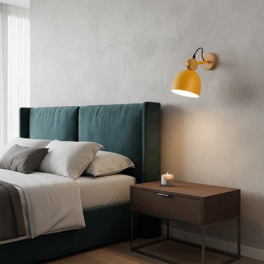 Table lamp wall mounted light beside modern bed creating warm ambient lighting for a cozy bedroom setting with minimalist decor.
