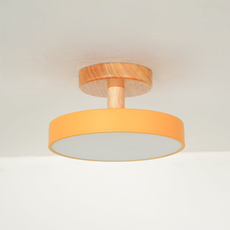 Modern mustard metal and natural wood ceiling light for stylish bedroom and Scandinavian home decor spaces.