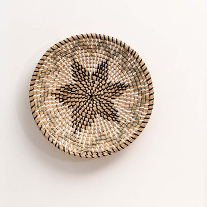 Natural handcrafted woven wall basket with floral star design for artistic wall styling and contemporary home decor.