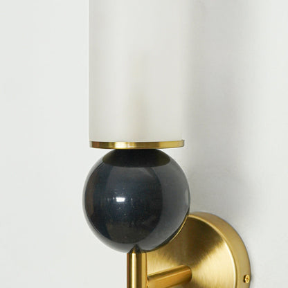 Close view of black glass shade with gold metal base highlighting premium modern wall light design for luxury interior decor lighting.


