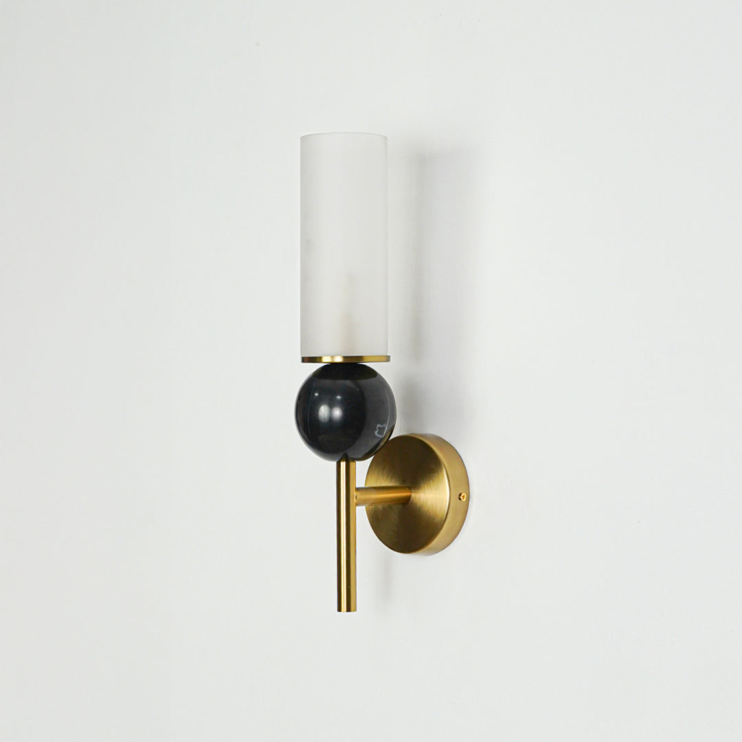 Minimal wall sconce with black glass shade and gold backplate on clean white wall background ideal for stylish bedroom or hallway lighting.