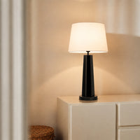 Black metal table lamp with white fabric shade for bedroom bedside table and living room ambient lighting.
