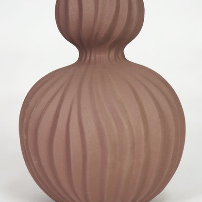 Closeup image of brown ceramic fluted vase for modern living room table decor with elegant matte finish styling.