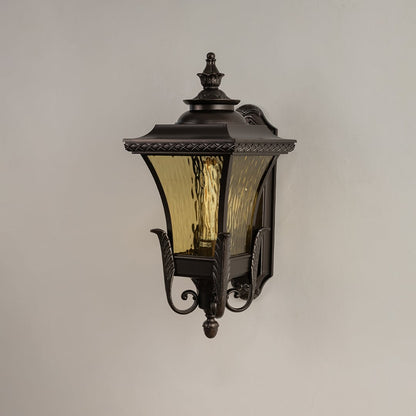 Bronze metal outdoor wall light on white background with 54 cm height and amber ripple glass shade for patio decor.