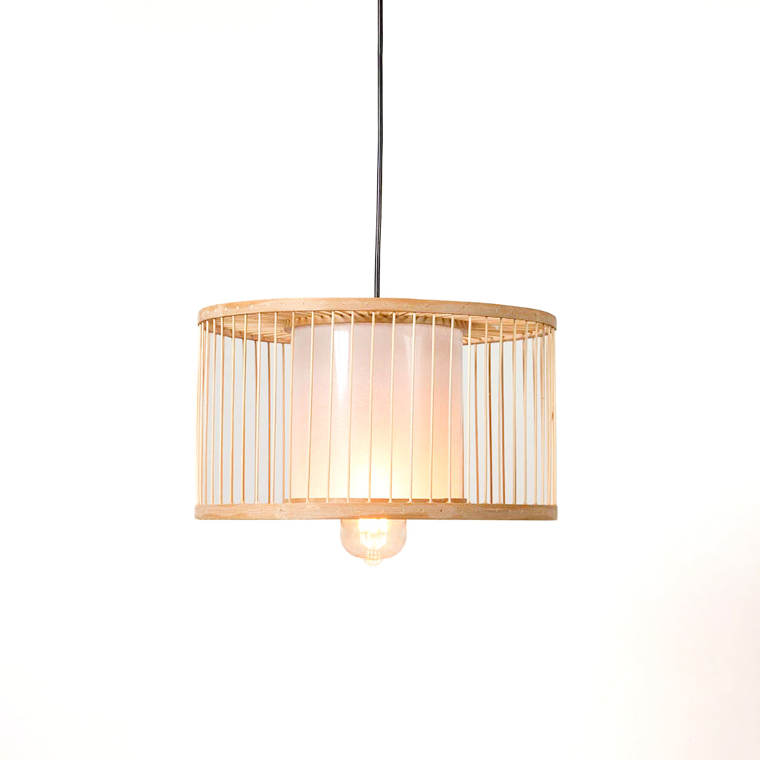 Minimal wood pendant light with cylindrical shade and subtle vertical lines suspended against clean neutral wall background for modern interior lighting.

