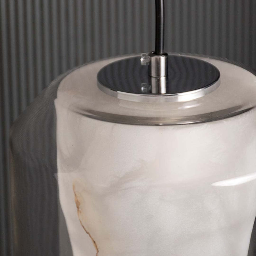 A closeup of the marble glass pendant light highlighting the frosted inner marble texture and sleek outer transparent cylinder for elegant modern interior lighting.