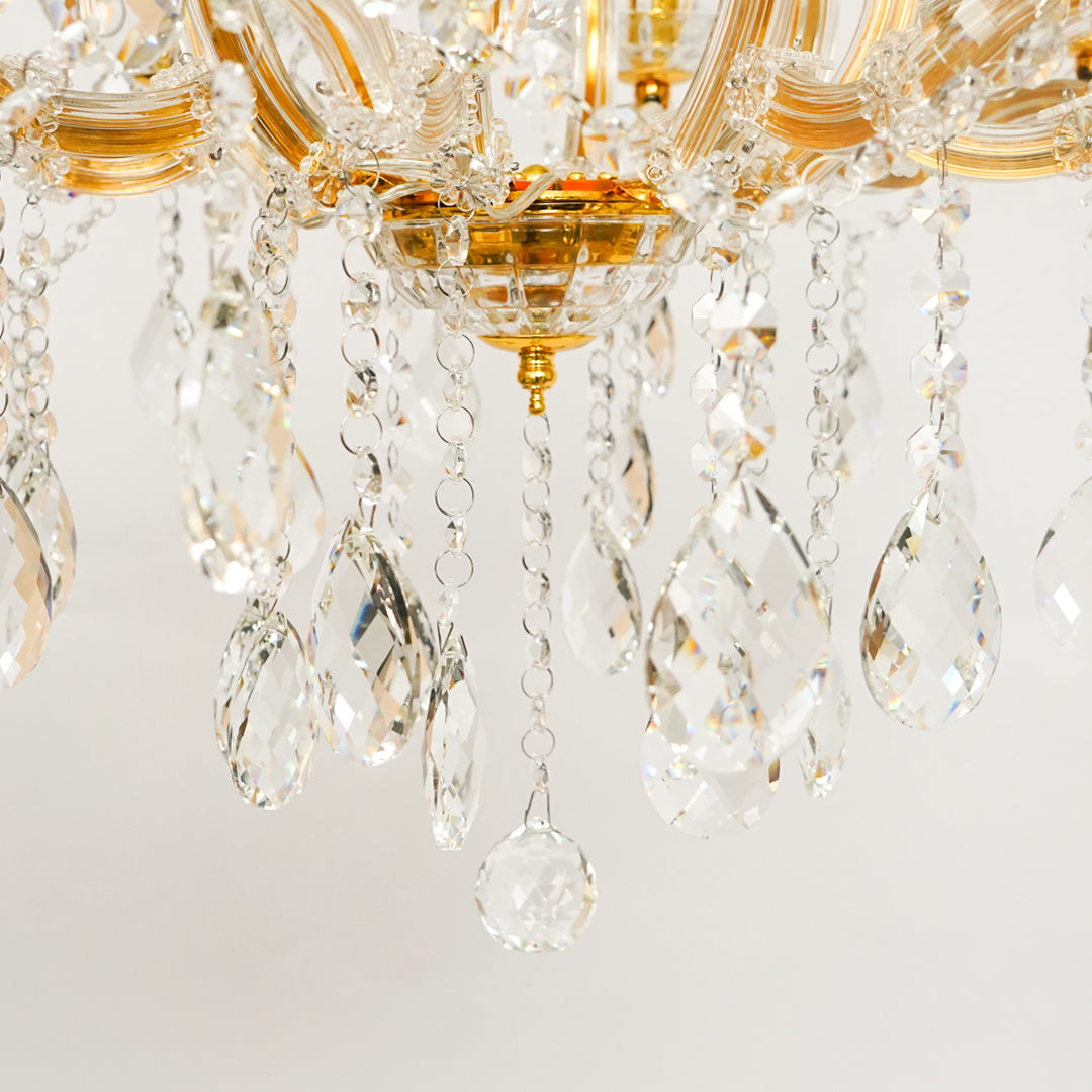 Detailed closeup image of eight light gold transparent crystal chandelier for modern ceiling decor styling with luxury look.