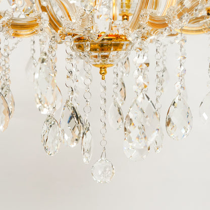 Detailed closeup image of eight light gold transparent crystal chandelier for modern ceiling decor styling with luxury look.