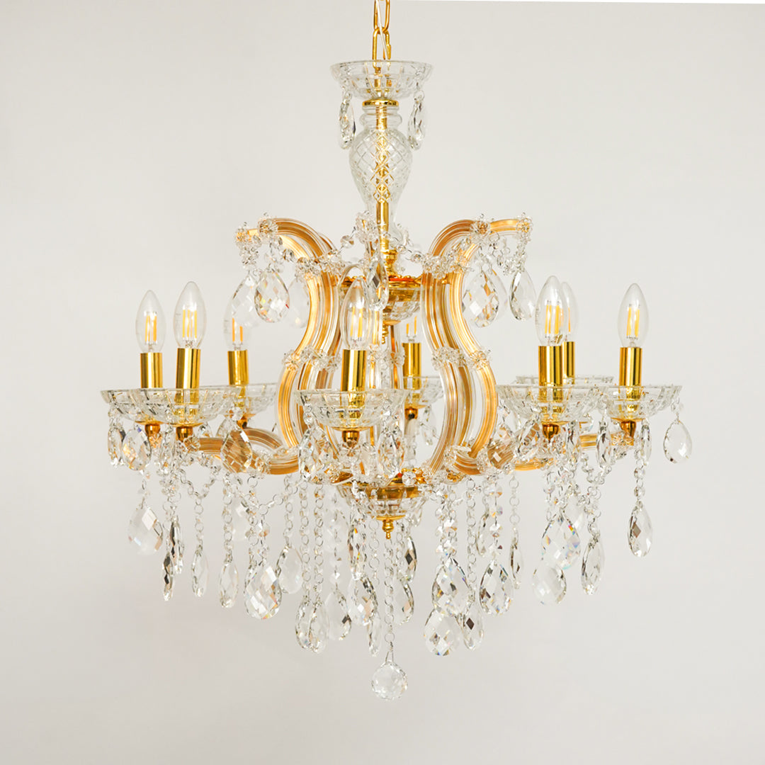 White background image of eight light gold transparent crystal chandelier for modern ceiling decor styling with elegant look.