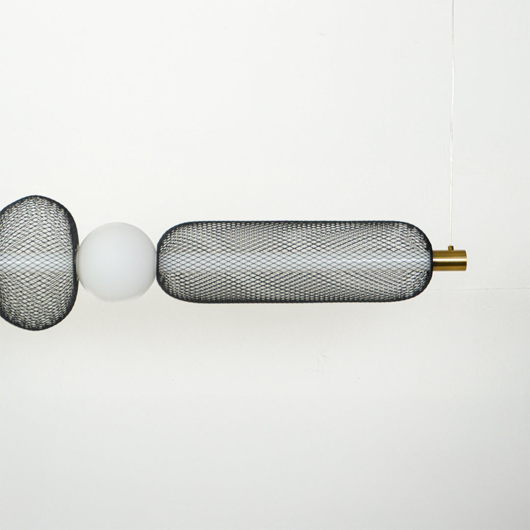 Close view of horizontal wall sconce with ribbed glass shades and metal detailing showcasing premium modern lighting design on clean background.
