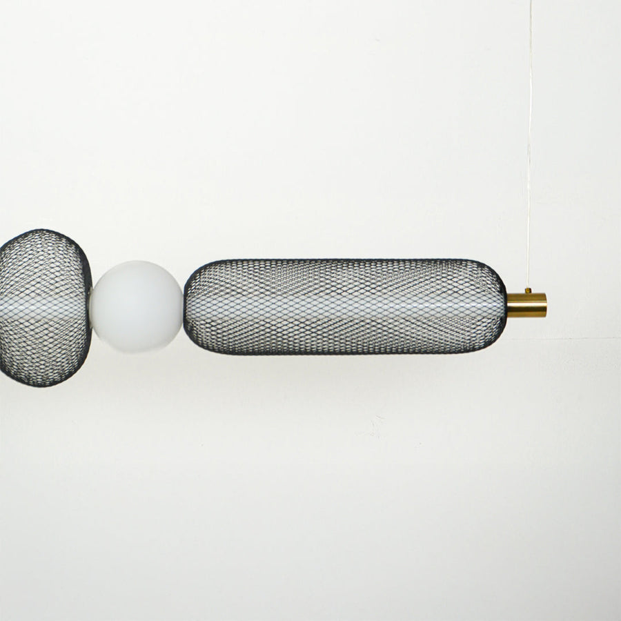 Close view of horizontal wall sconce with ribbed glass shades and metal detailing showcasing premium modern lighting design on clean background.