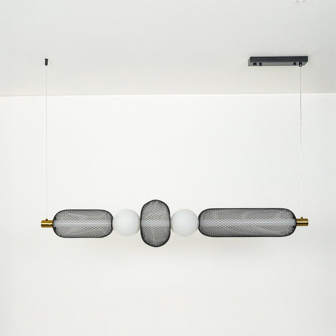 Modern wall light with textured glass cylinders and metal accents mounted on neutral wall background ideal for contemporary bathroom or hallway lighting.