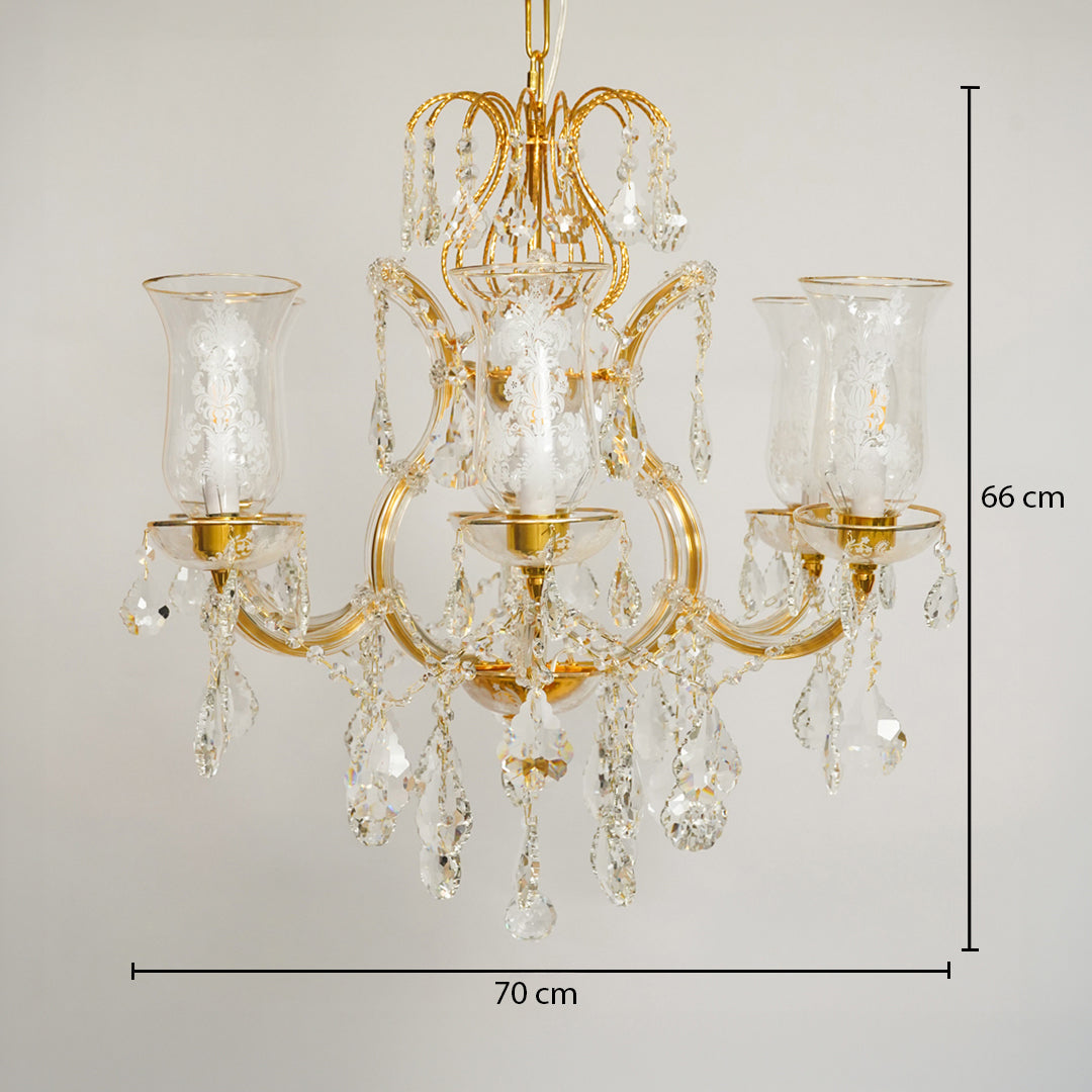A gold three-light chandelier with clear crystal droplets and glass candle-style shades, shown against a light gray background with dimension lines indicating 70 cm width and 66 cm height.