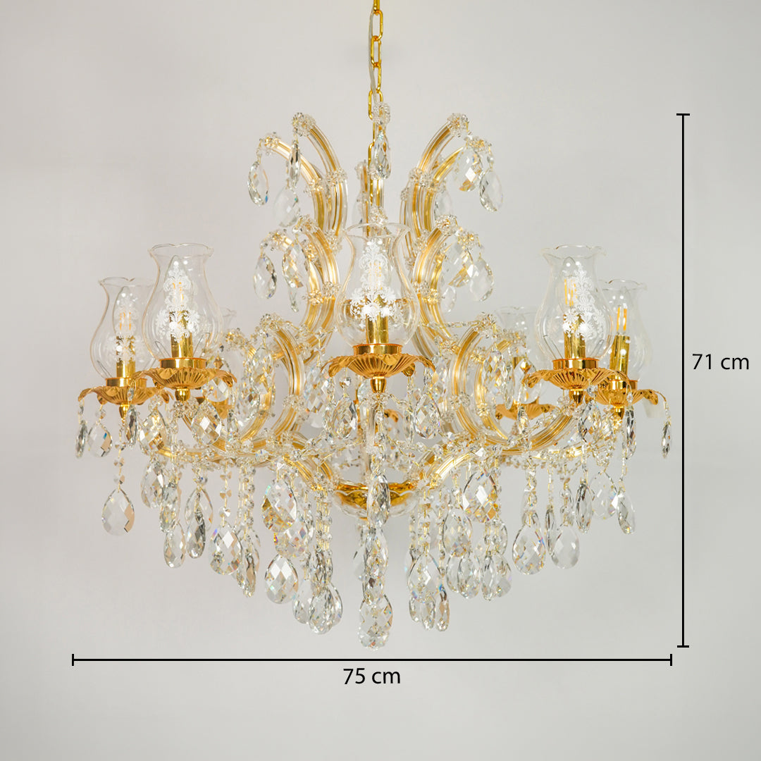 Gold chandelier with clear crystal drops and glass shades, shown against a light gray background with dimension lines indicating 75 cm width and 71 cm height.