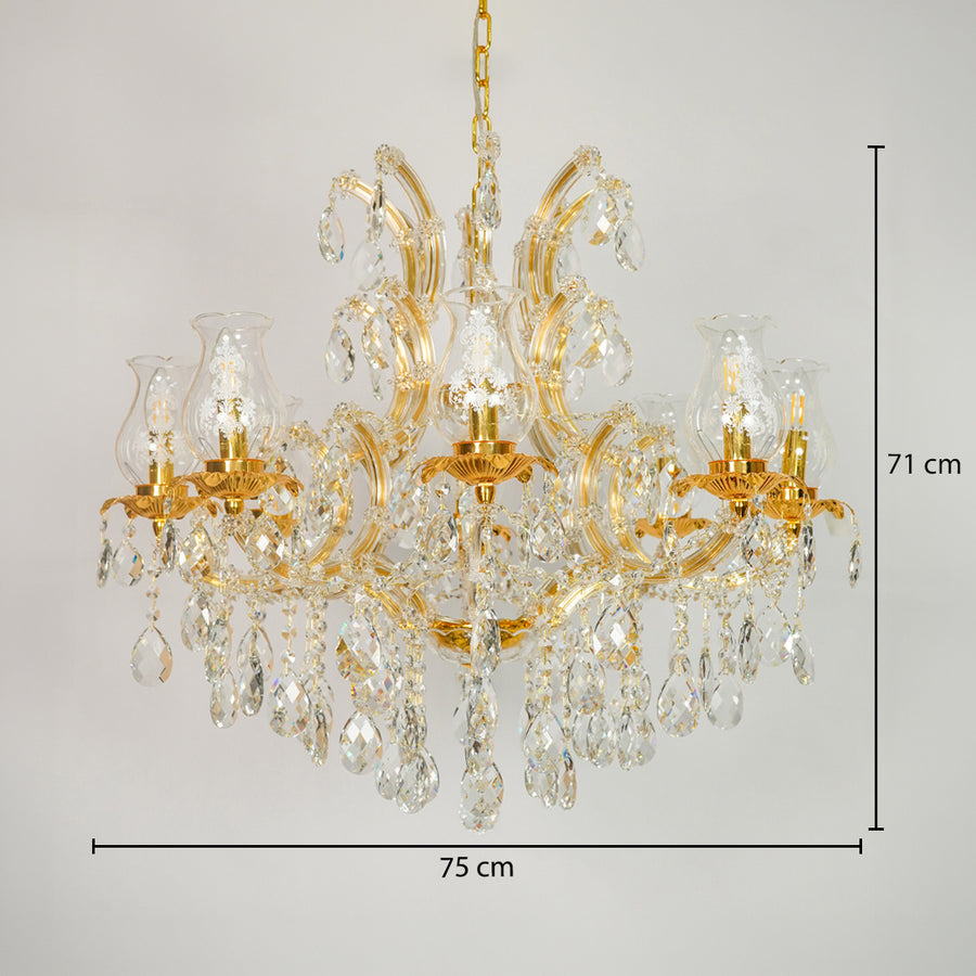 Gold chandelier with clear crystal drops and glass shades, shown against a light gray background with dimension lines indicating 75 cm width and 71 cm height.