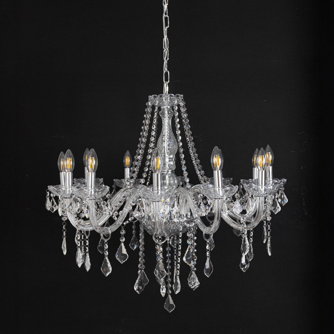 Chandelier with silver detailing and crystal droplets displayed off against black background for stylish home style.