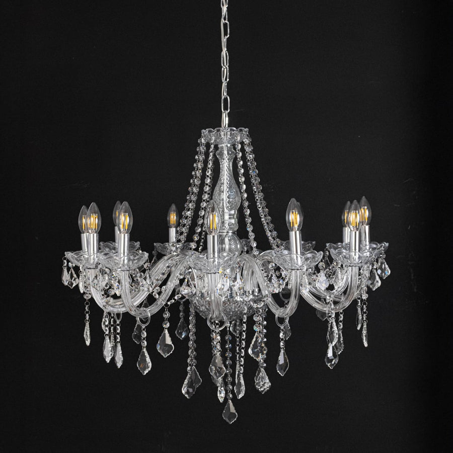 Chandelier with silver detailing and crystal droplets displayed off against black background for stylish home style.