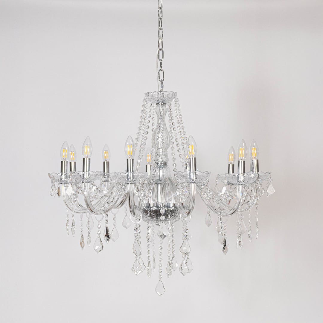 Classic chandelier with silver finish and crystal accents displayed off on white background for luxury home decor.