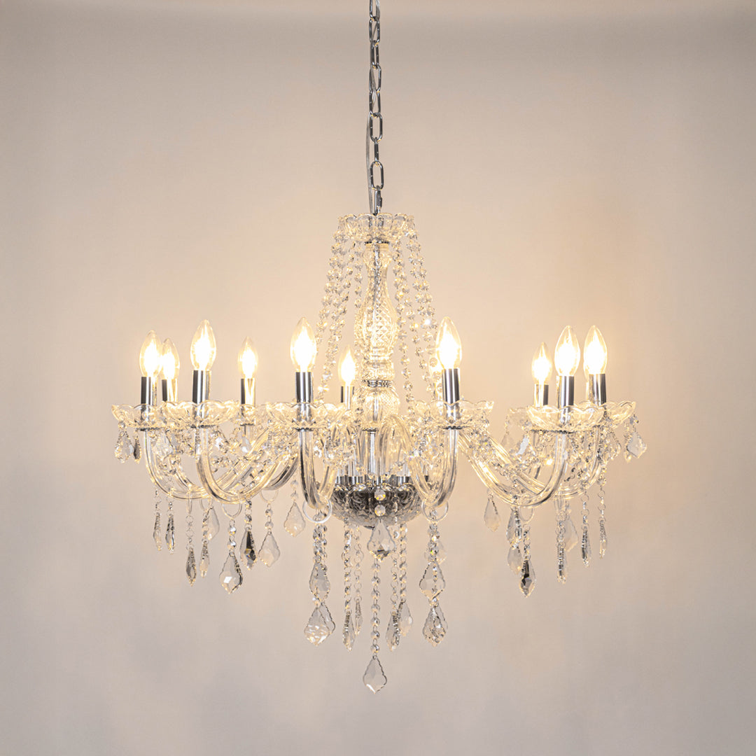 Clear crystal chandelier with illuminated candle bulbs and crystal drops creating timeless luxury ceiling lighting for homes.