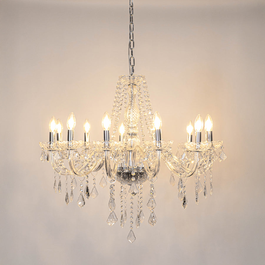 Clear crystal chandelier with illuminated candle bulbs and crystal drops creating timeless luxury ceiling lighting for homes.